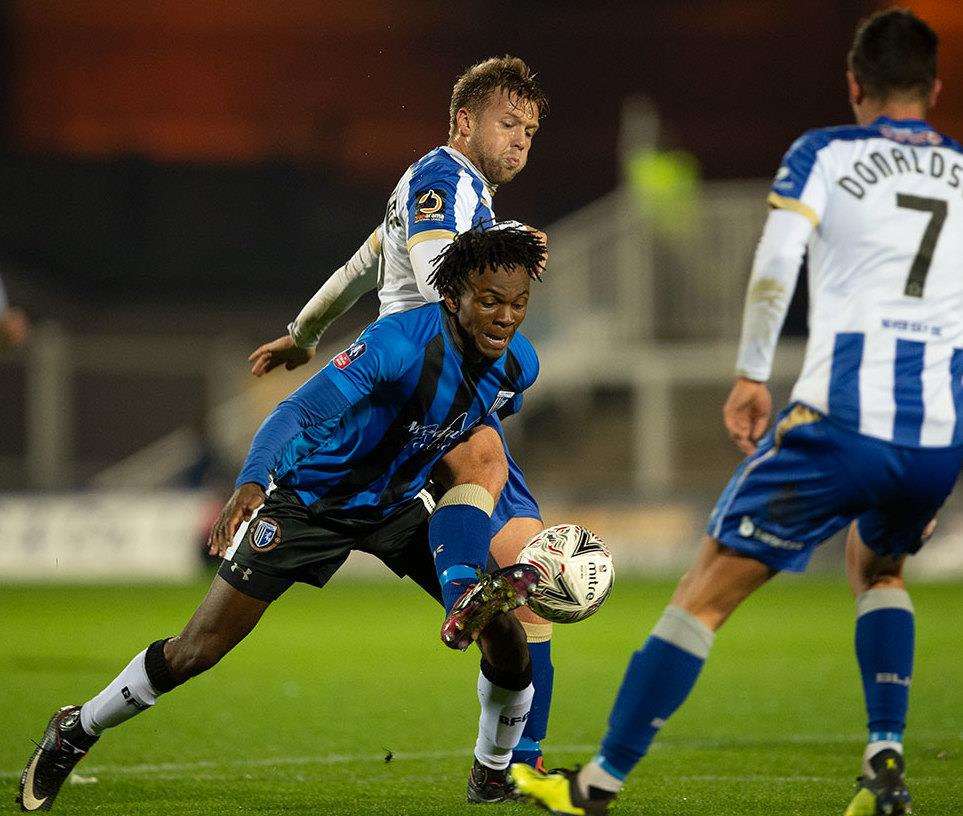 Gillingham's Regam Charles-Cook tries to win the ball back Picture: Ady Kerry