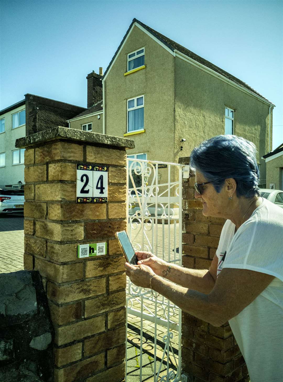 A visitor learns more about Rev Benjamin Winston's home in Rhyl thanks to the new QR codes as part of a history project uncovering secret links to the slave trade. Picture: HistoryPoints