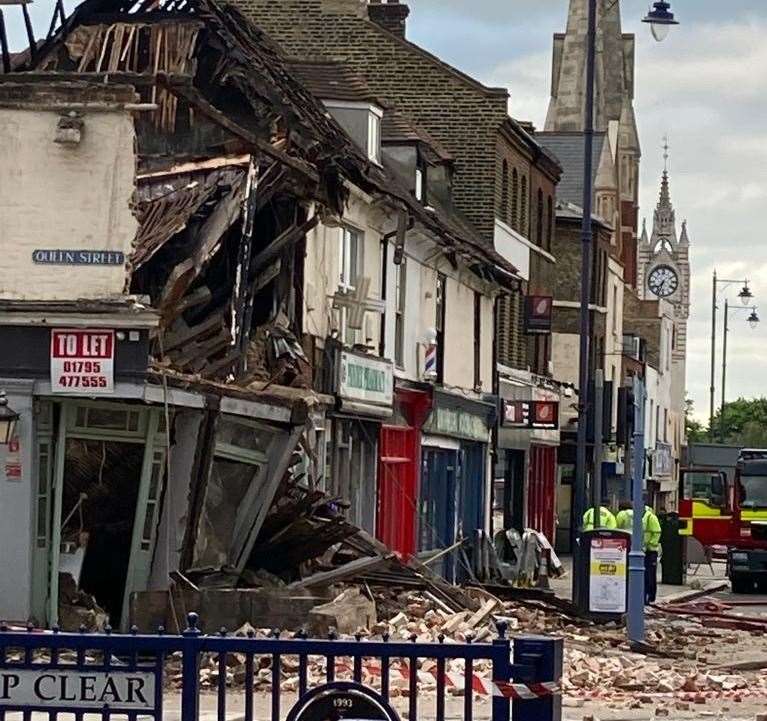 The building has collapsed into the street prompting the road closure