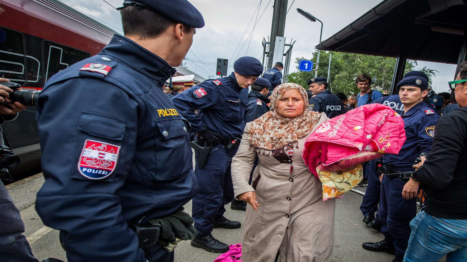 Refugees who have crossed the border from Hungary board a train to Munich from Nickelsdorf, Austria. Picture: SWNS.com