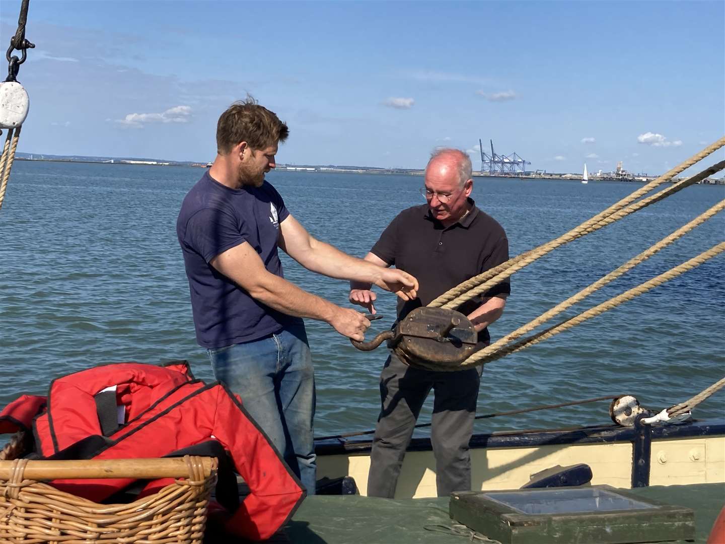 Richard Murr gets some instruction from Ed Gransden aboard the Thames sailing barge the Edith May