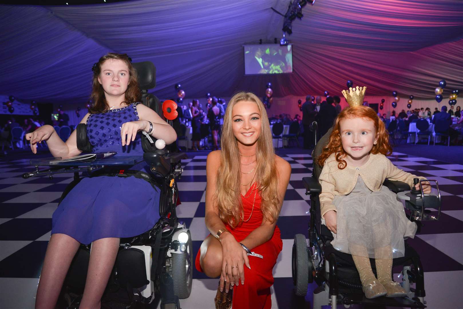 Shelby with Katy and Beau, two young girls who have been helped by the Friends of Shelby Newstead charity with the purchase of mobility chairs