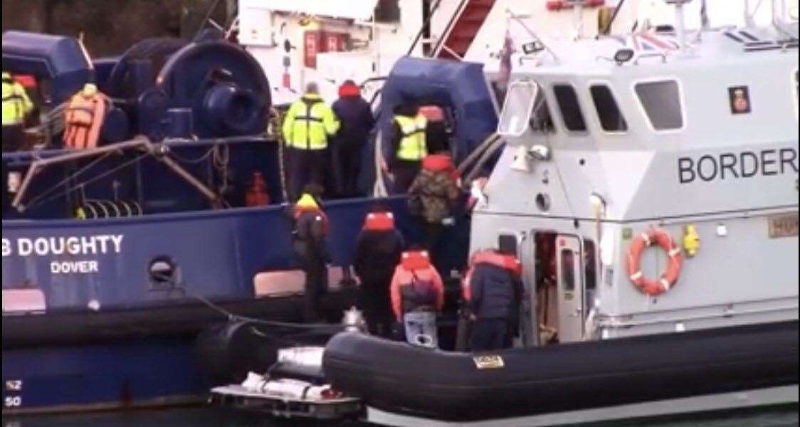 People are seen in life jackets and leaving a Border Force cutter