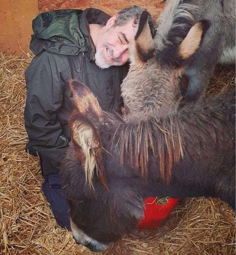 Andy Larkin was able to tick 'hug a donkey' off his bucket list before he passed away after hugging Pedro and Poncho