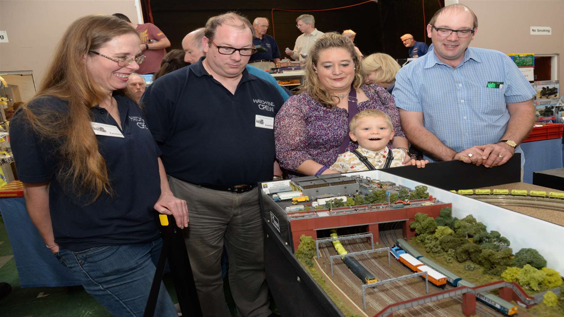Susan Lee and Laurence Williams part of the team who built the 'Hatch End' layout show off their layout to Nicola, Jacob, two and Richard Lewis at the charity model railway exhibition in St Michael's Church Hall, Wilmington on Saturday. Picture: Chris Davey