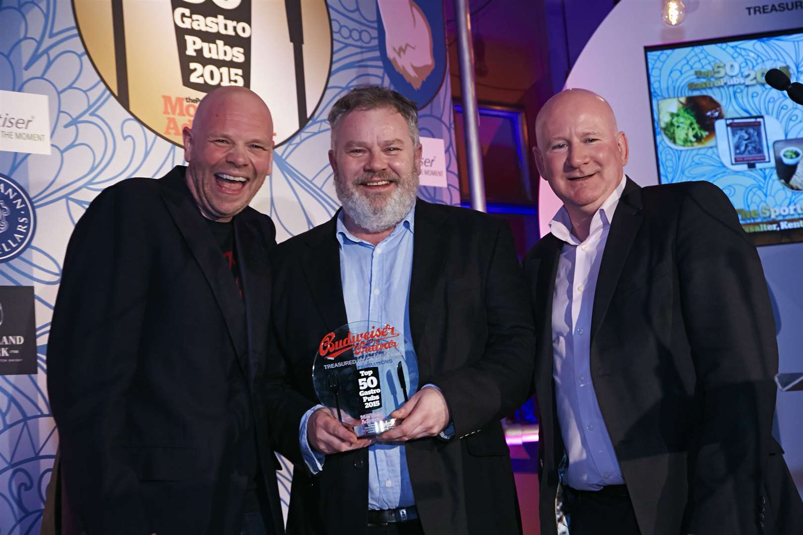 Celebrity chef Tom Kerridge, left, presents the Sportsman in Seasalter with the award for being named Britain's best gastropub