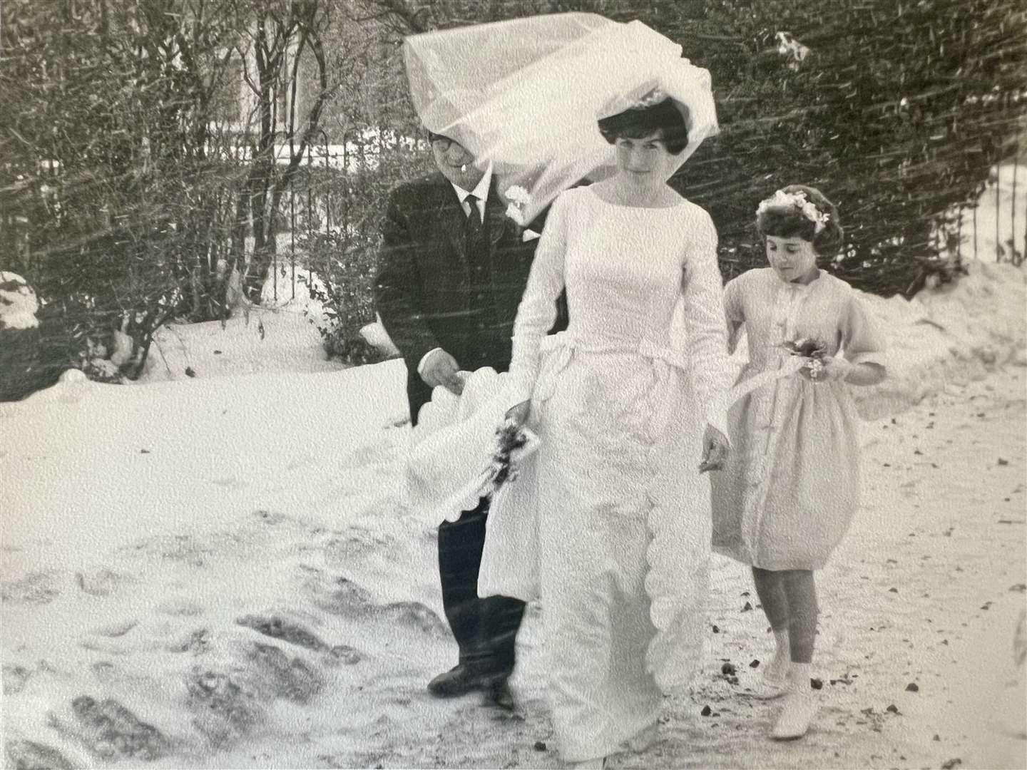 Here comes the brrrr-ide: Janet only in her wedding dress in the freezing cold with her father George and bridesmaid. Picture: Terry and Janet Blackmore