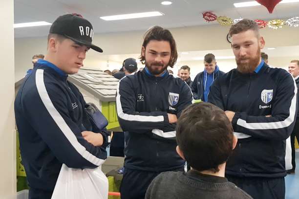 Gillingham players chatting to a fan