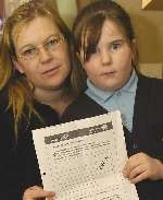 Sharon Underwood and daughter Chloe with the homework set by a teacher. Picture: NICK JOHNSON