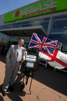 Charity fundraiser, Whistling Postman Dale Howting, poses with his Collecting 'bike at Homebase, Sittingbourne.