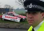 WARNING: PC David Brett with the anti-drink wrecked vehicle at the Four Elms roundabout near Chattenden