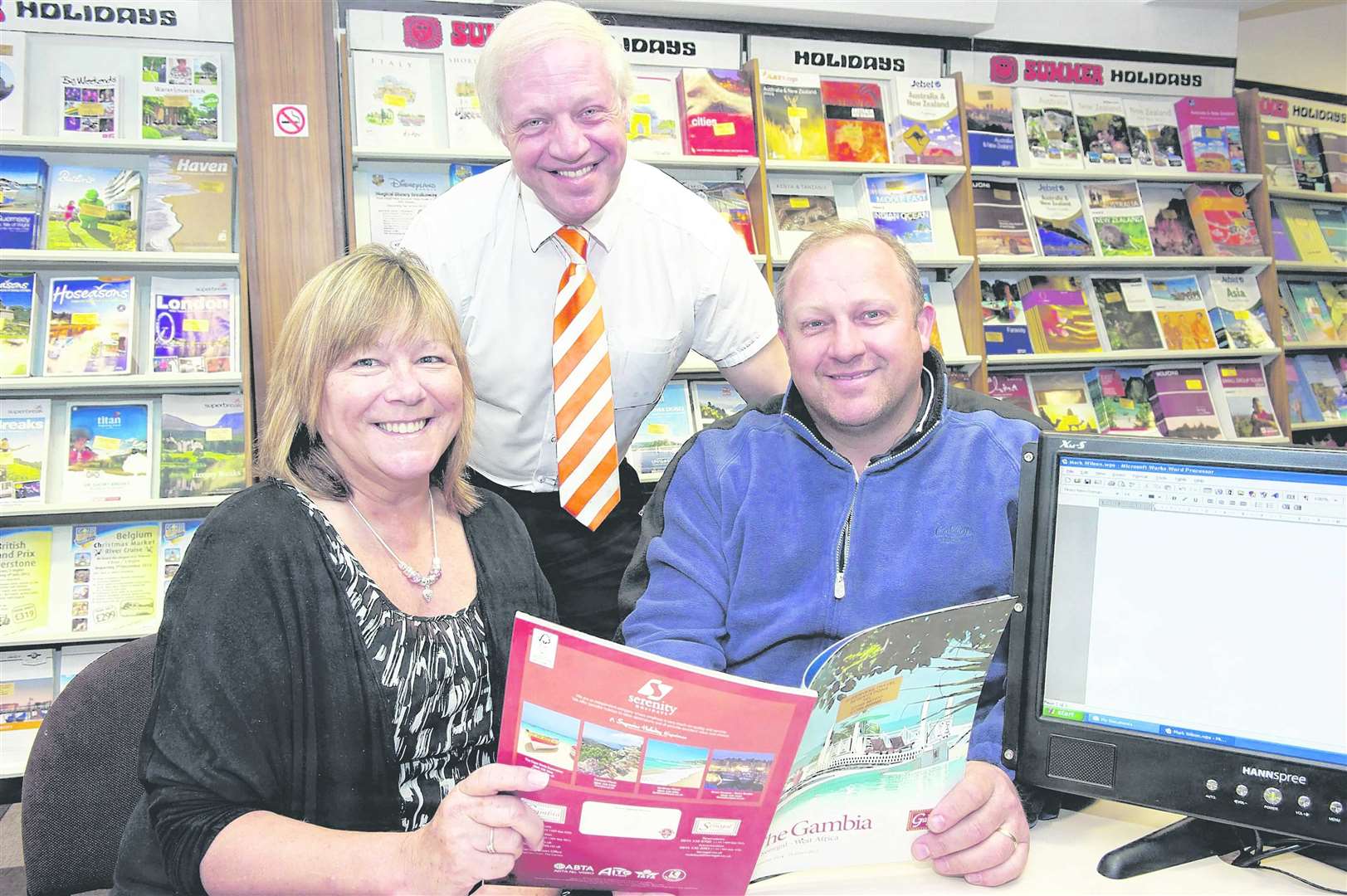 David Lynch of Sheerness Travel agency with customers Sharon and Sean D'Alton. Picture: Andy Payton