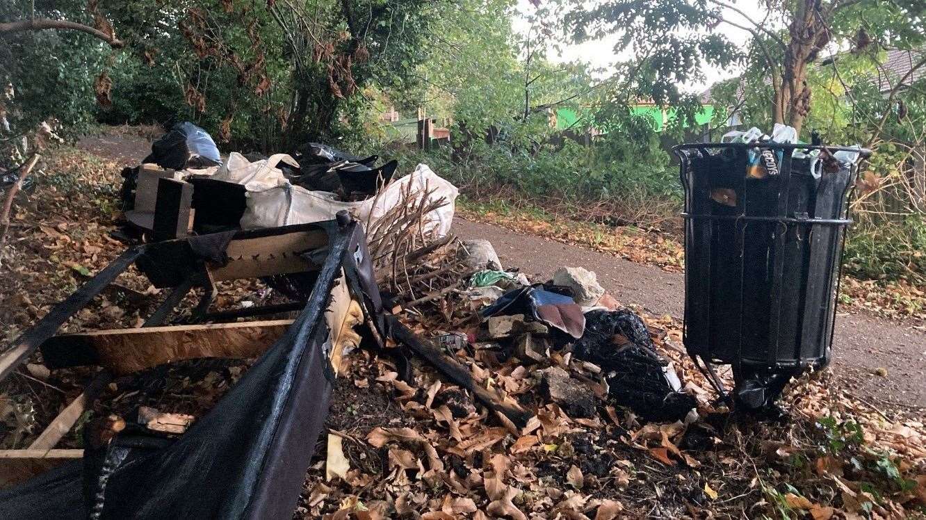 Waste fly-tipped in woods near Hales Place, Canterbury, that has been placed in an alley for the council to collect