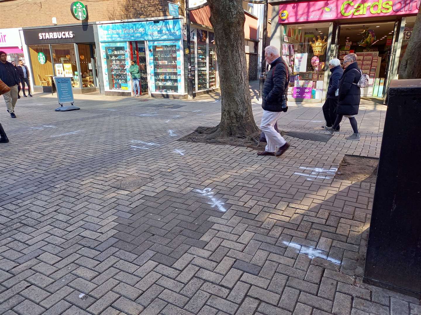 White markings have been sprayed across the high street pavement