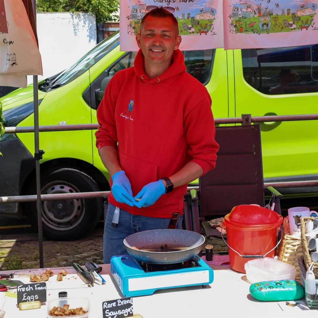 Queenborough Harbour's first quayside market on Saturday attracted crowds and several stalls like this one with Kyle Ratcliffe from Curly's Farm which did a roaring trade selling its sausages. Picture: Queenborough Harbour Trust
