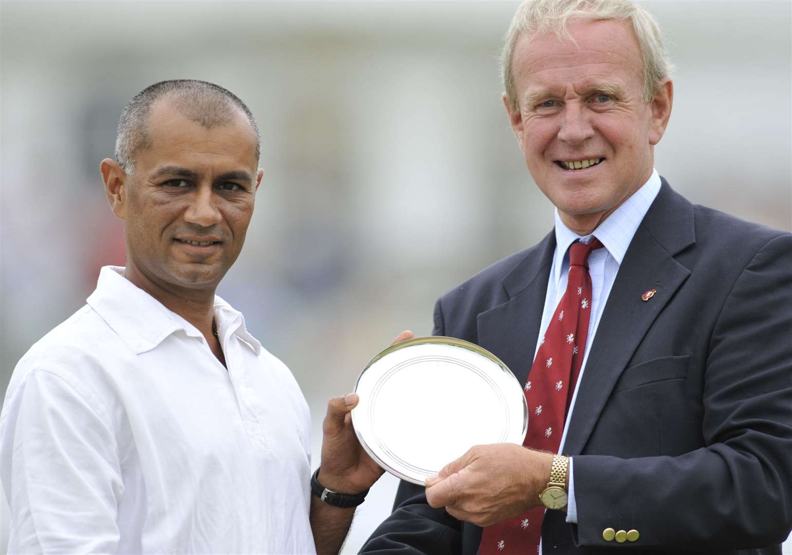 Min Patel is presented with a silver plate by Derek Underwood at Canterbury’s Spitfire Ground. Picture: Barry Goodwin