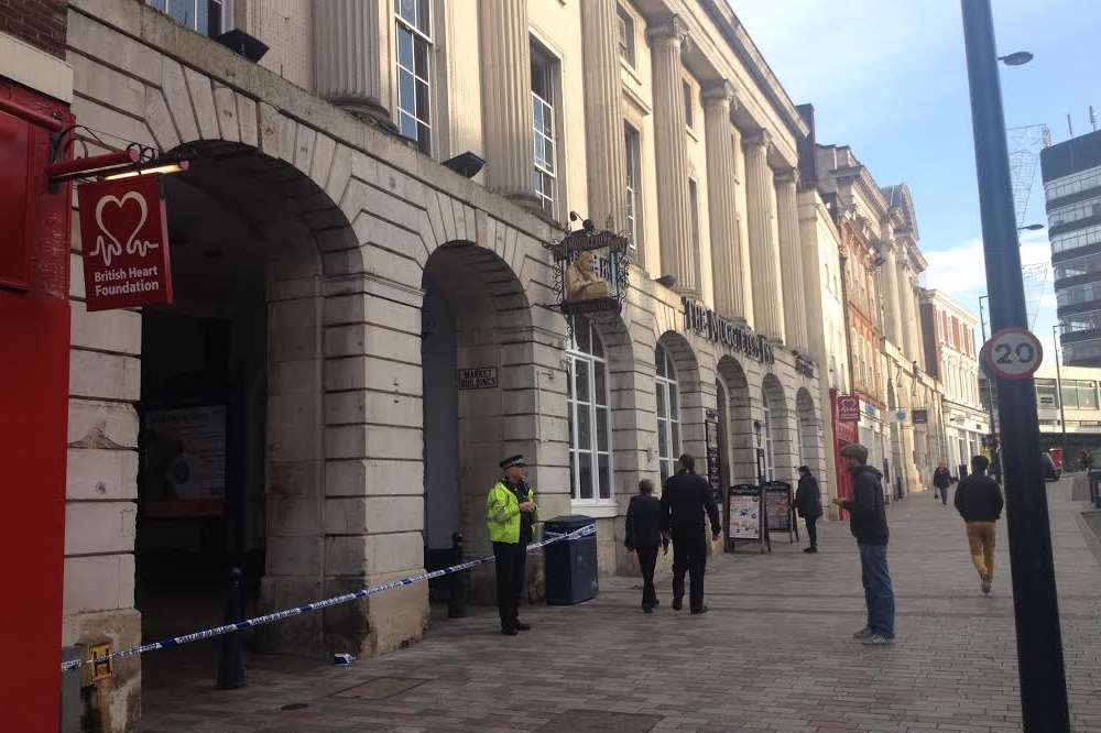 Police are at the High Street entrance of Market Buildings.