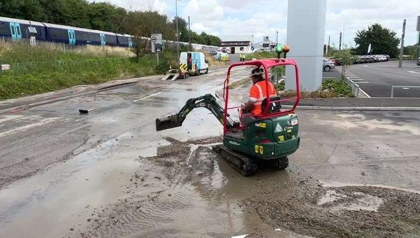 Workers repairing the burst water mains