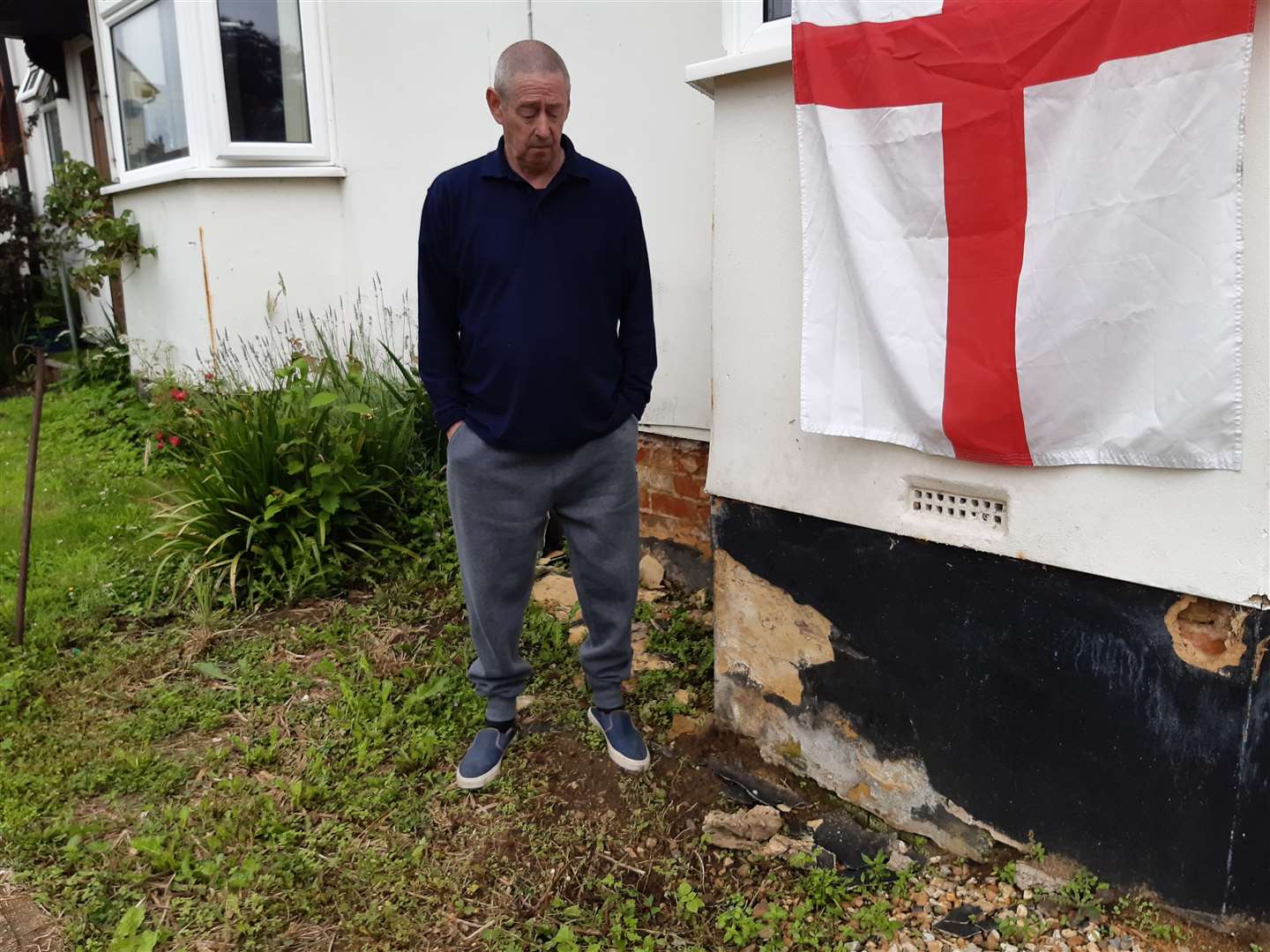 Former bin man Ron Garrott next to a small void in his front garden, which increased in size after recent heavy rainfall