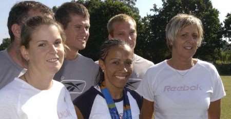 Kelly Holmes at her old school in Tonbridge this week with her former PE teacher Debie Page, right, and other staff. Picture: JOHN WARDLEY
