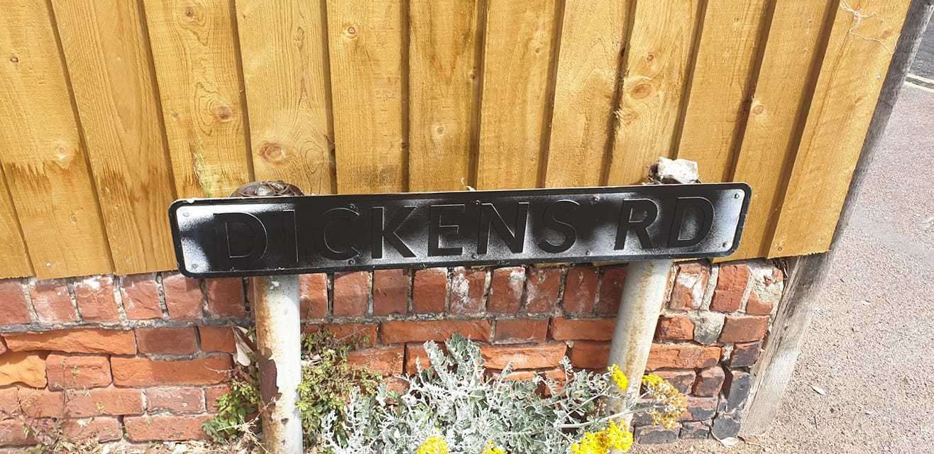 The street sign in Dickens Road has been defaced