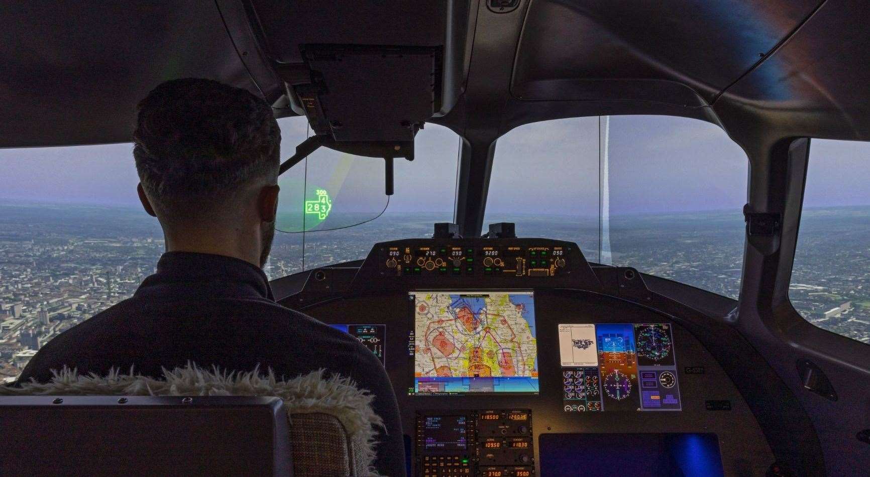 A test pilot flying in one of the site’s state-of-the-art simulators, trialling head-up display technology developed by Rochester technicians.