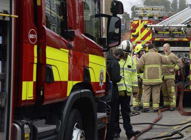 Fire fighters helped release a man from a car that had become trapped under the trailer of a lorry.