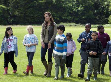 The Duchess of Cambridge walks with children from King Solomon Academy