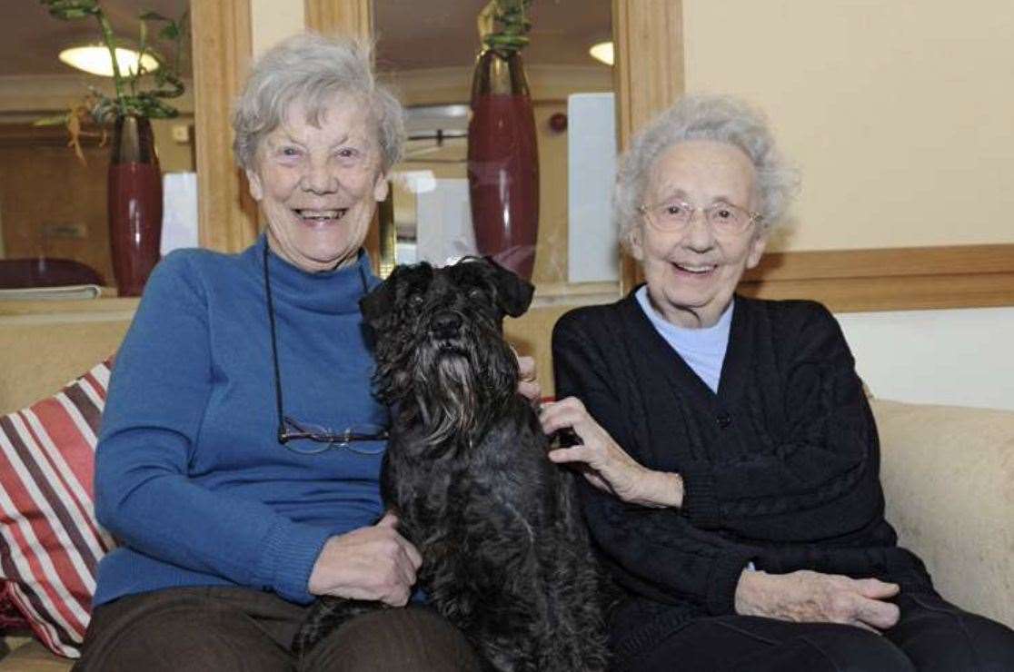 Two of the residents with beloved home dog Morse