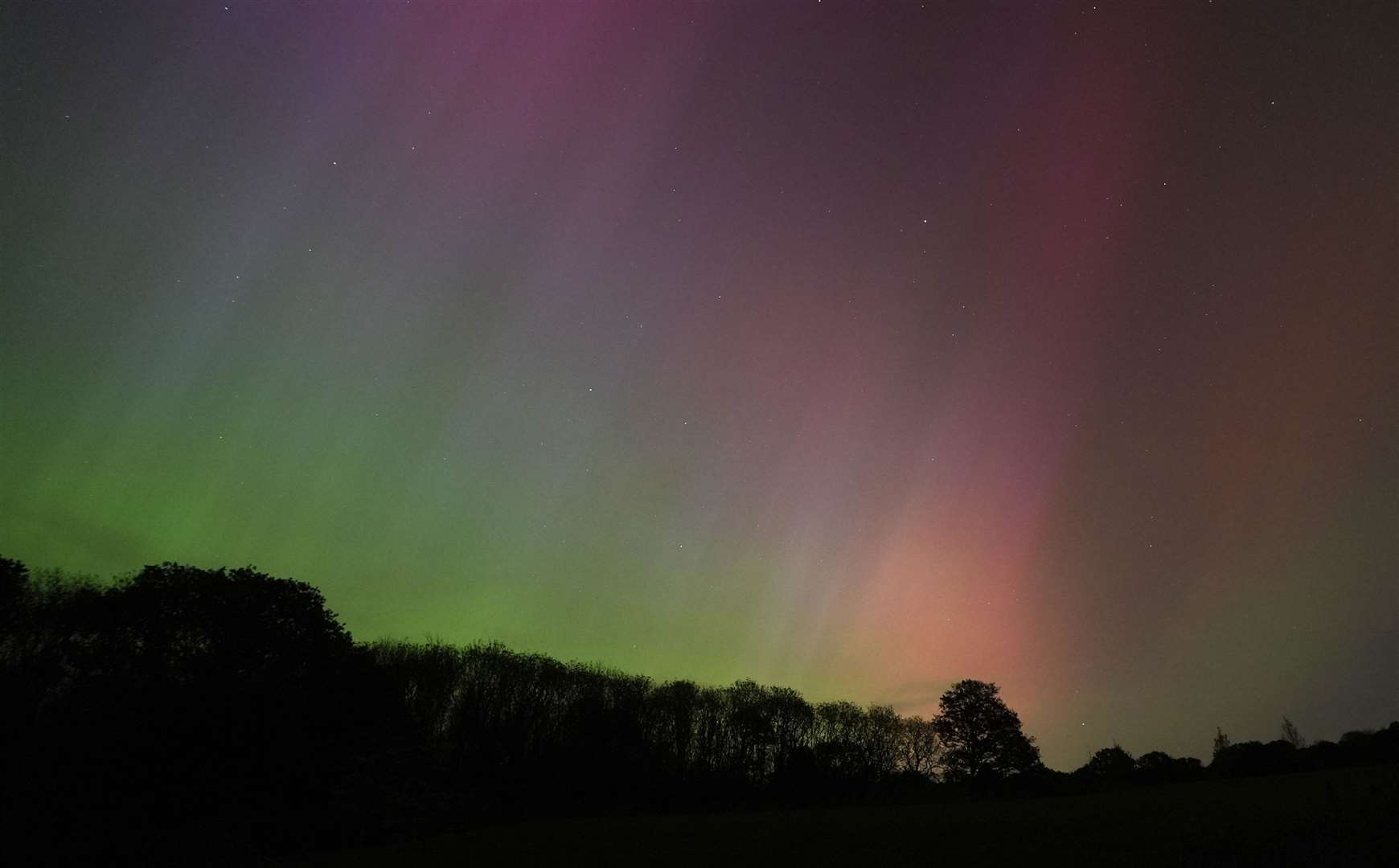 The light show glows on the horizon over Basingstoke in Hampshire (Andrew Matthews/PA)