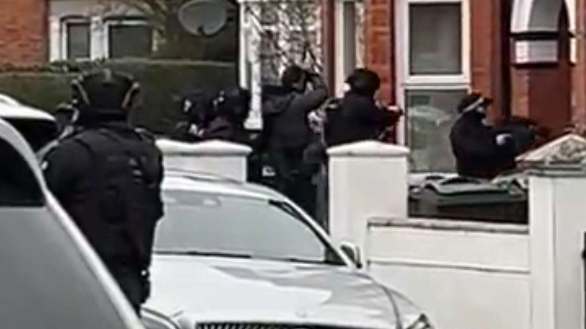 Armed police were seen entering a house in Godinton Road