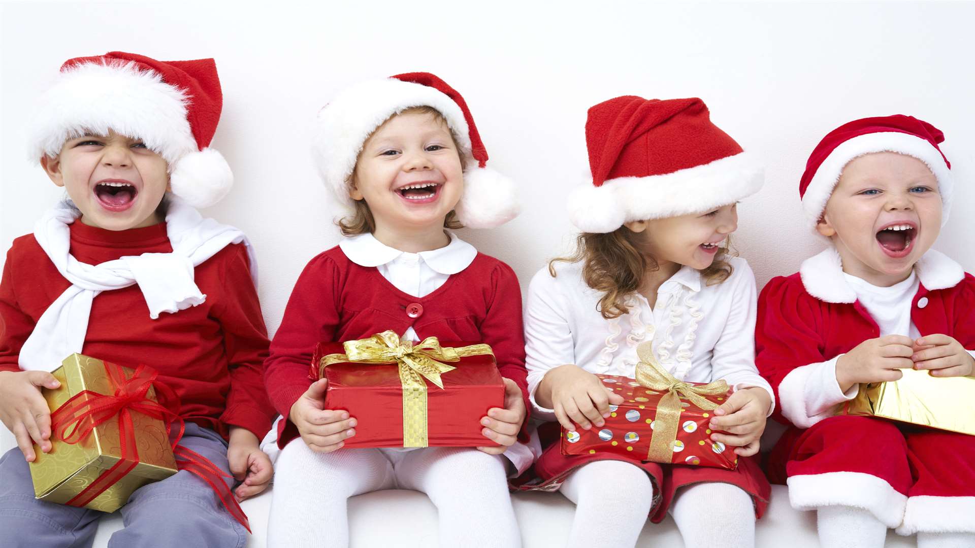 A group of children with Christmas presents to open