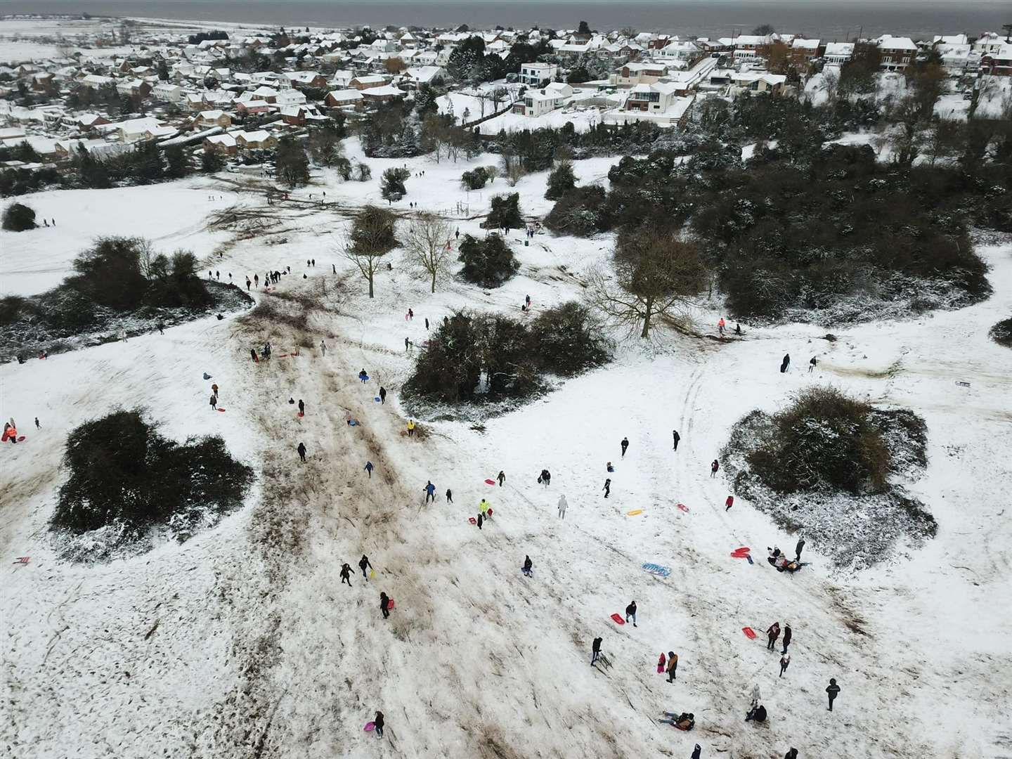 Drone picture of people looking like ants having fun in the snow in The Glen at Minster on the Isle of Sheppey. Picture: Henry Cooper