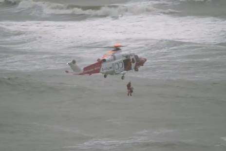 The rescue helicopter from Lydd winching the woman from the sea. Picture: @ReeldealHD/Twitter