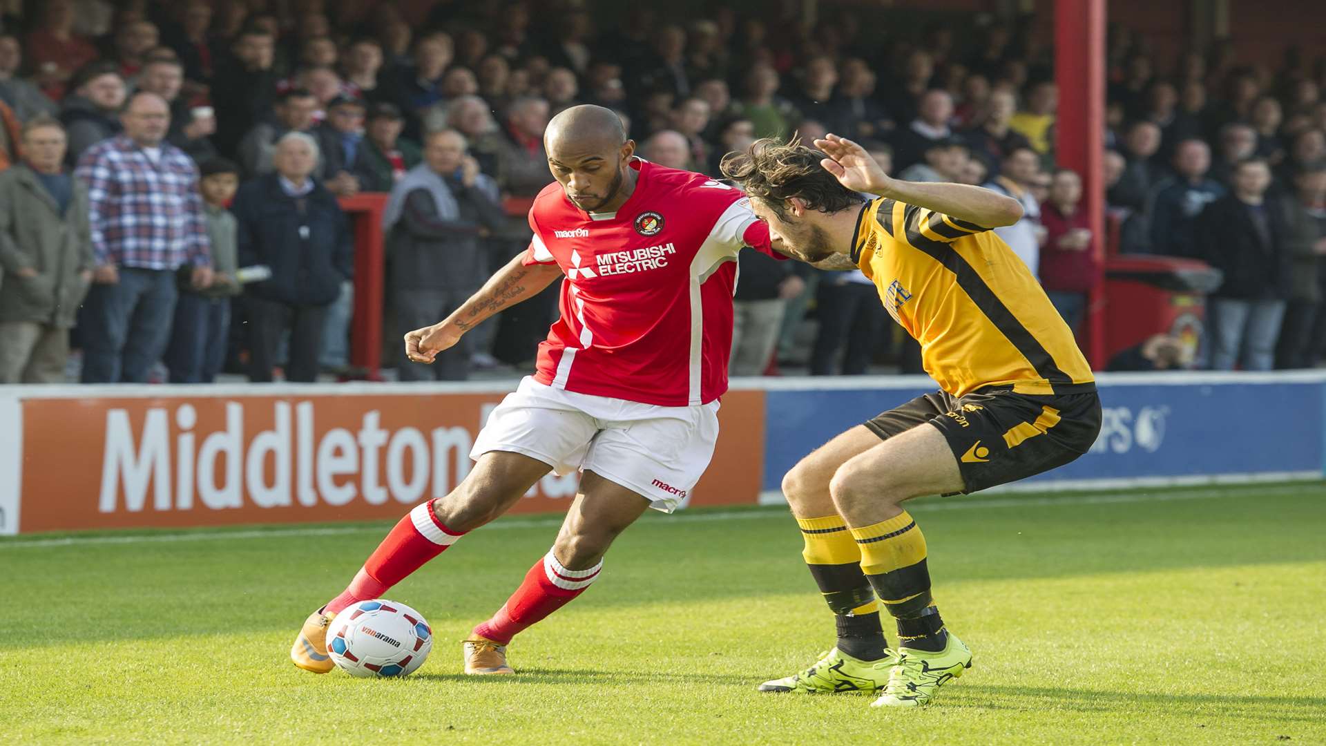Danny Haynes takes on Maidstone full-back Tom Mills Picture: Andy Payton