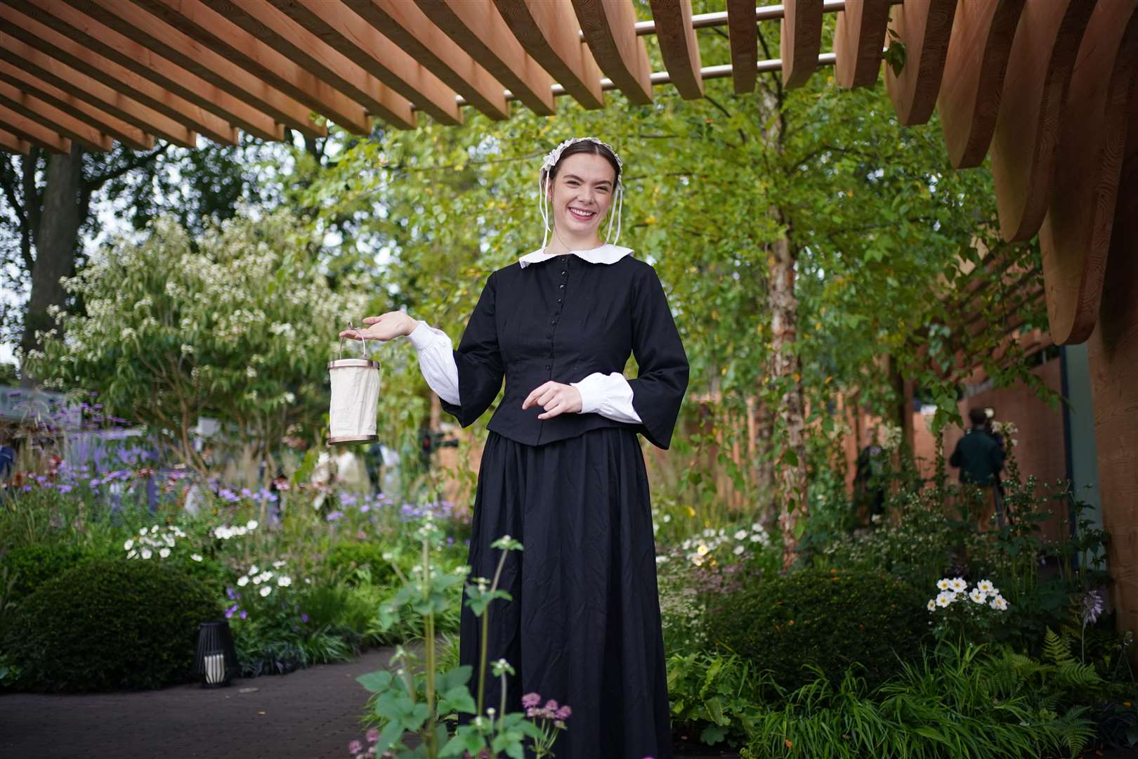 A woman dressed as Florence Nightingale in the Florence Nightingale garden at the RHS Chelsea Flower Show (Yui Mok/PA)