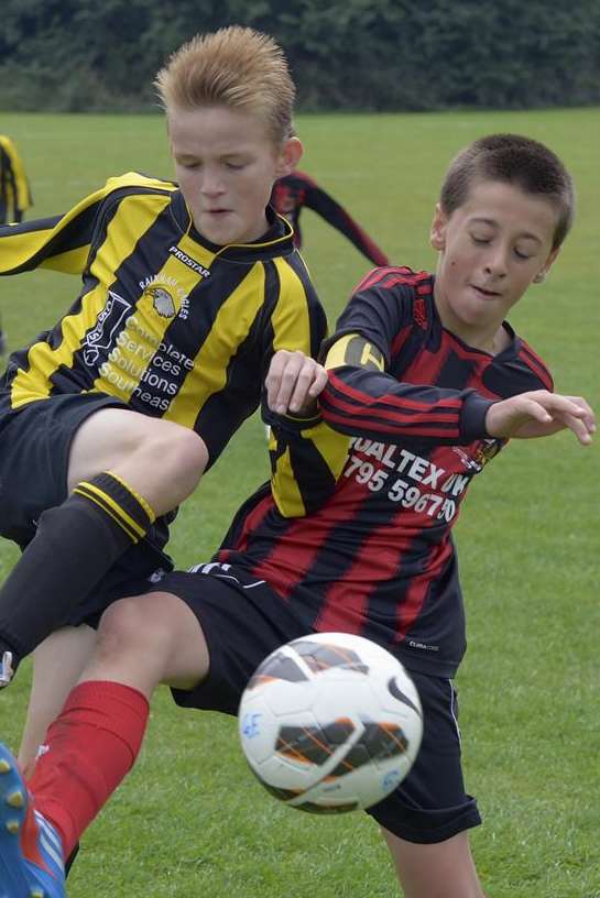 Woodcoombe Youth under-12s, red and black stripes, battle Rainham Eagles under-12s. Picture: Andy Payton