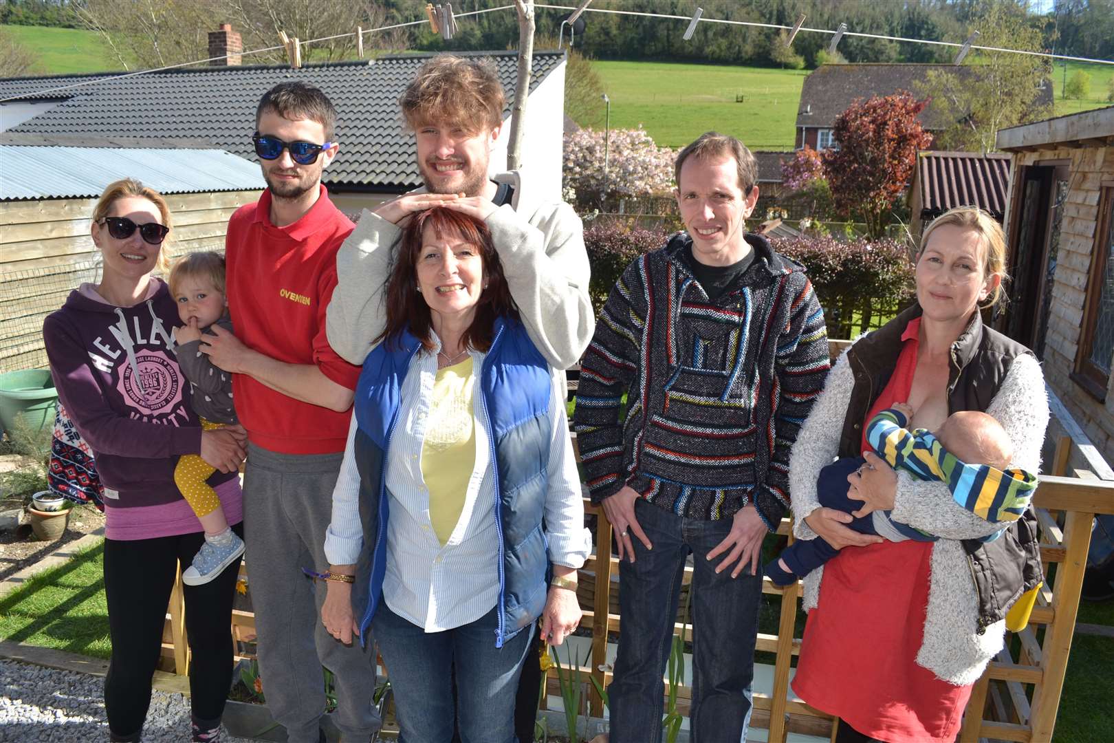 Rebecca (right) holding her son with her mother Lyn (centre) and siblings (l-r) Kate, Jacob, Jordan and Daniel