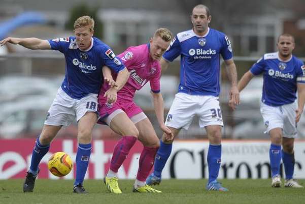 Joe Pigott finds himself outnumbered against Oldham Picture: Barry Goodwin