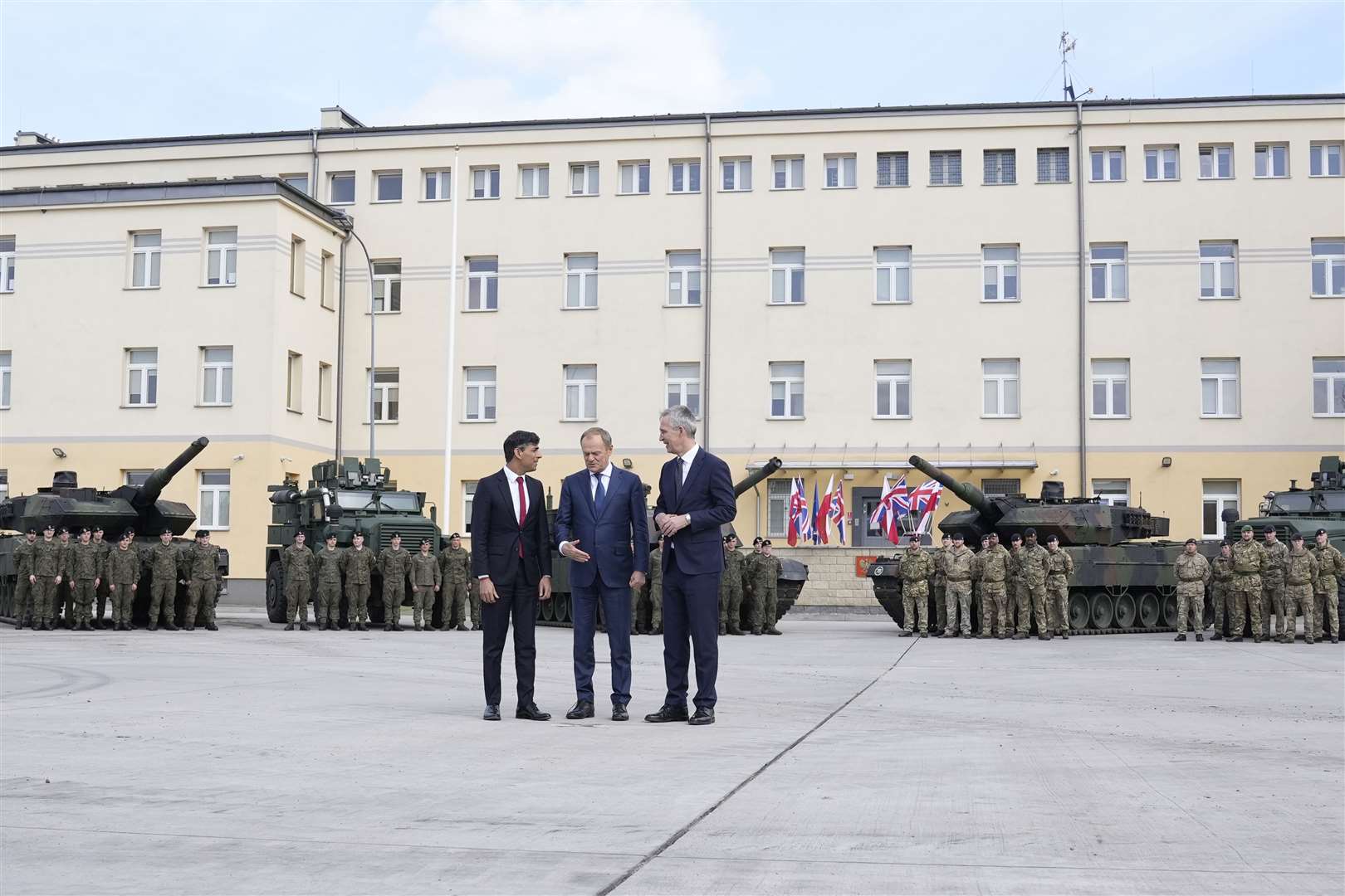 Prime Minister Rishi Sunak, Poland’s Donald Tusk and Nato’s Jens Stoltenberg at the Armoured Brigade barracks in Warsaw (Alistair Grant/PA)