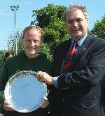 VICTORIOUS: Mel Clewlow receives the Super Cup trophy from Hockey Association president Martin Gotheridge