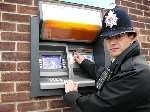 PC Ashley Price points out the area of a cash machine where customers need to beware