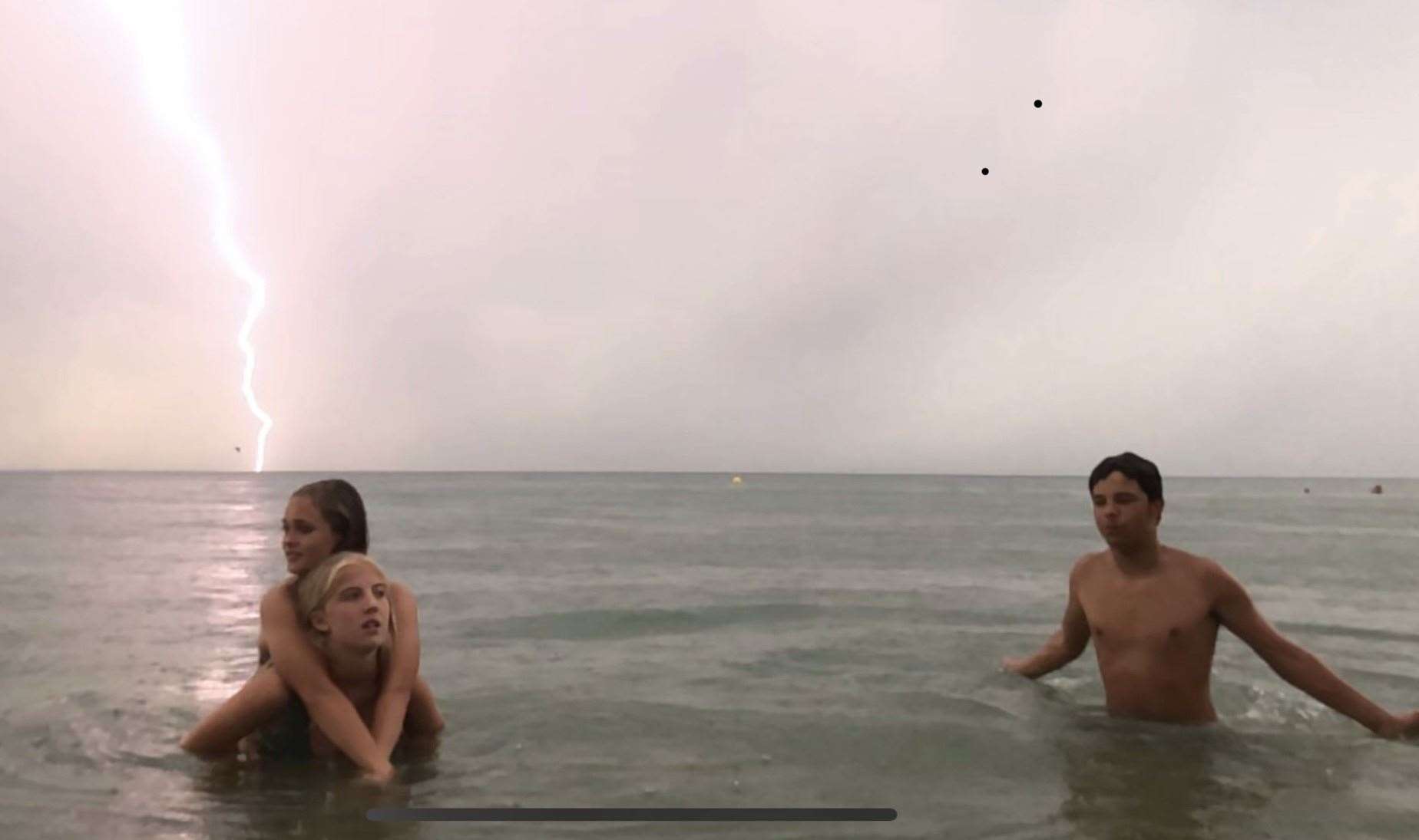 One beach-goer got more than they bargained for when they snapped lightning hitting the sea