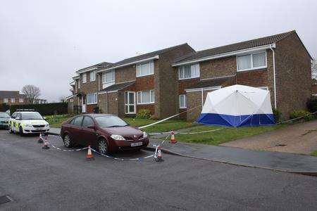 A police car, tape and a police tent outside the property under investigation in Farncombe Way, Whitfield.