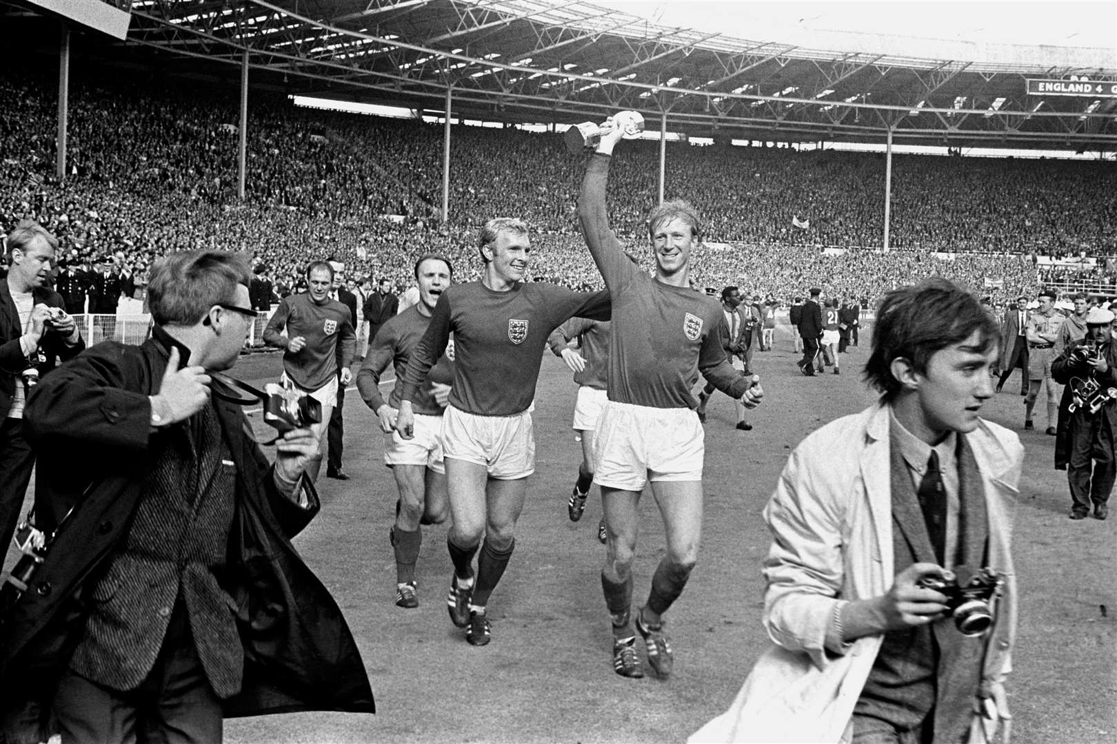 Jack Charlton holds the Jules Rimet trophy aloft as he parades it around Wembley following England’s 1966 World Cup final victory (PA)