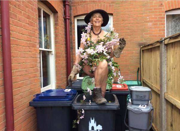 Sheila Miller posing in a wheelie-bin