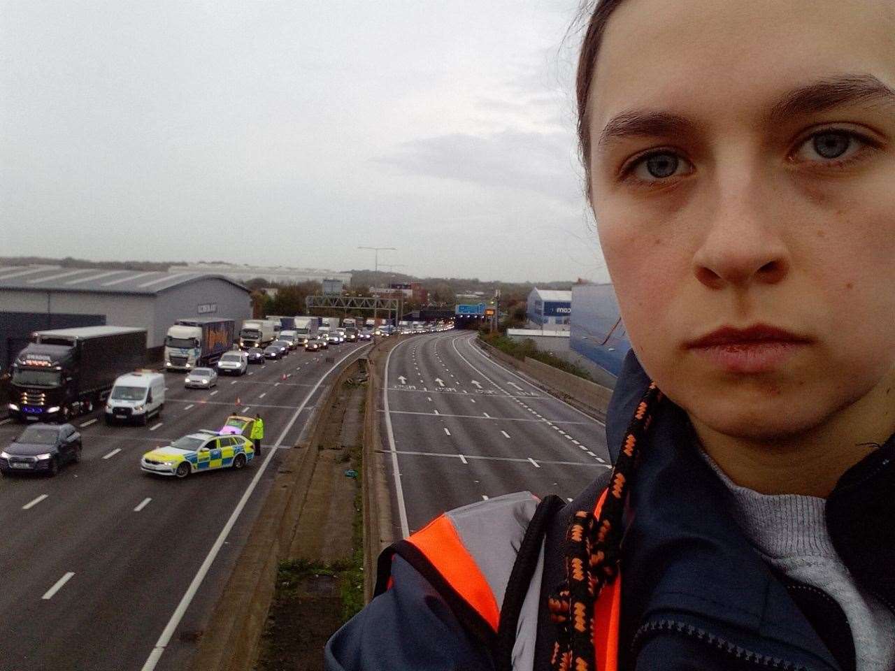 A Just Stop Oil protester on the motorway gantry