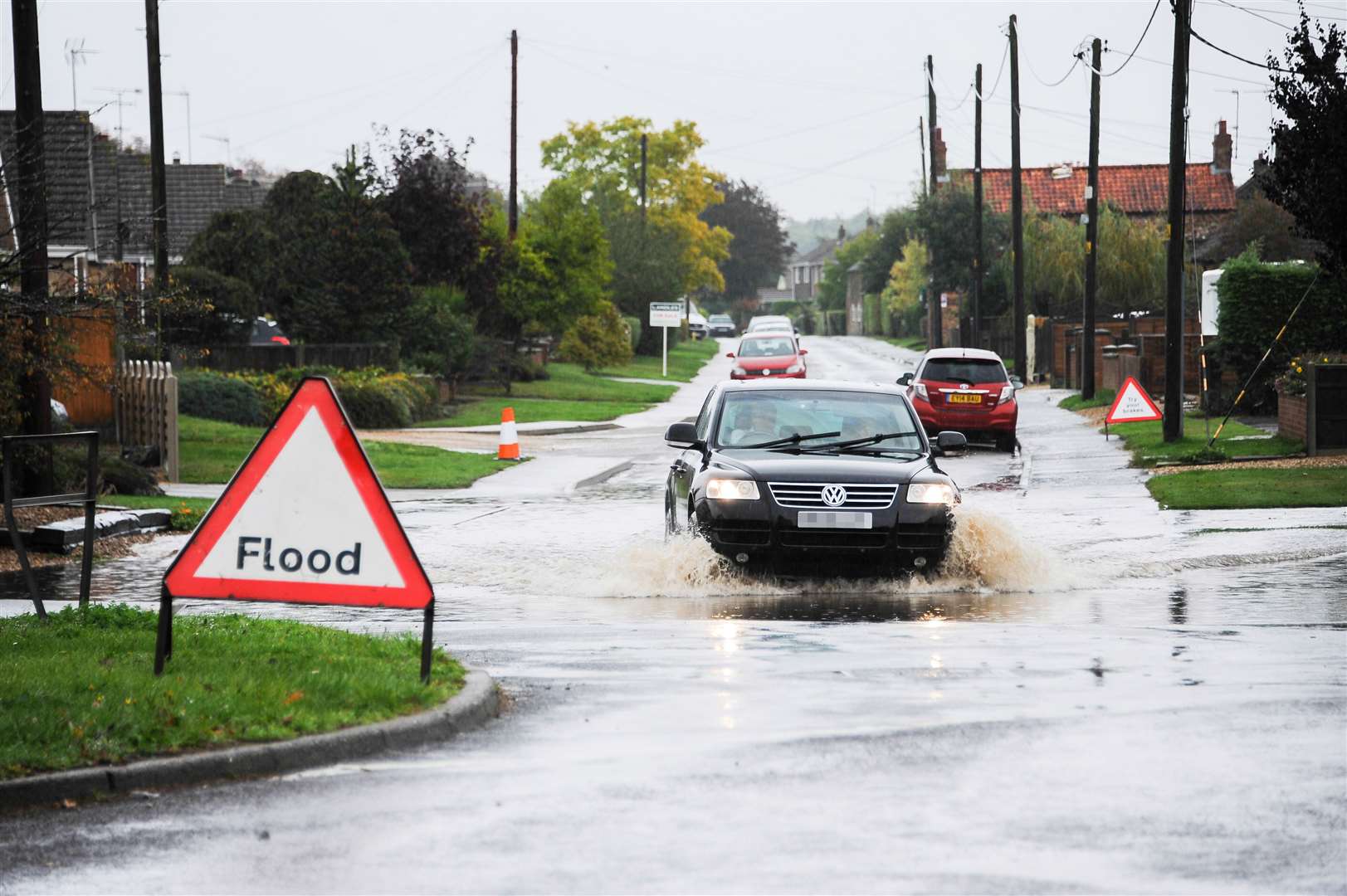 A vehicle makes its way through heavy flooding. Stock
