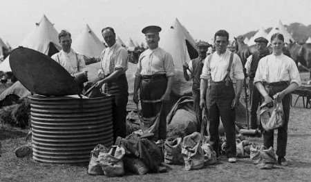 Royal East Kent Yeomanry filling nosebags for their horses in 1913.