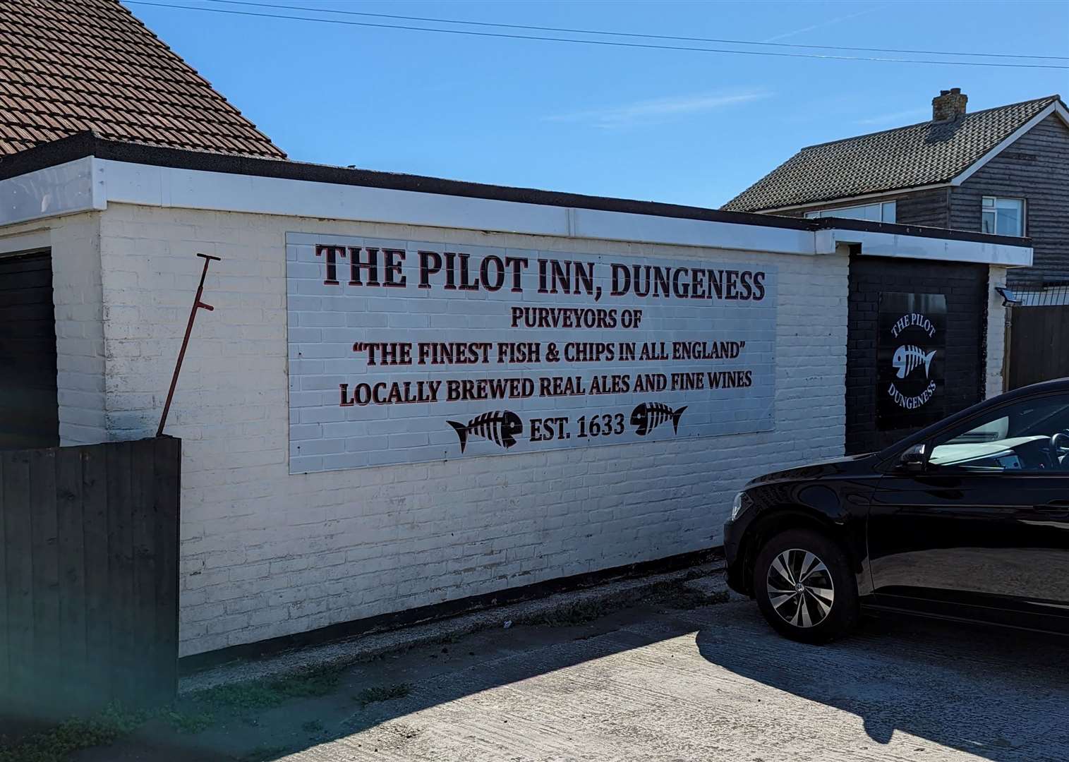 A sign outside The Pilot claims the seaside pub serves 'the finest fish and chips in all England'